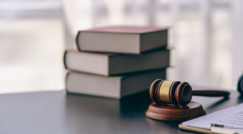 Gavel and Law Books Judge's gavel with books and a clipboard on a desk