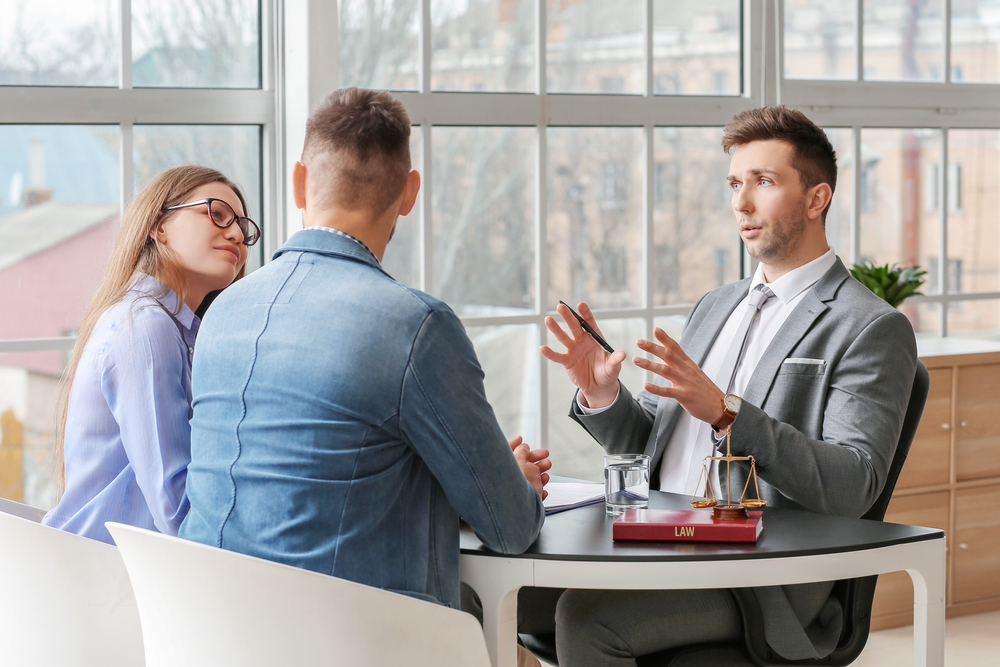Attorney at Work Photo of people sitting at the table and talking