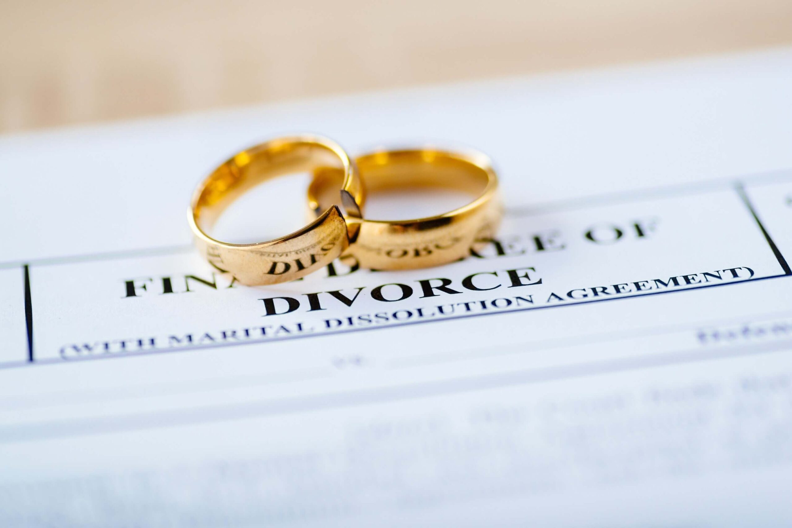 Two rings on top of documentations for divorce Two rings over documents