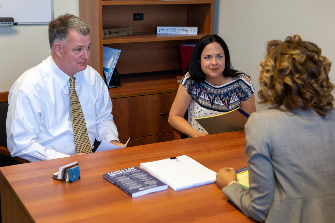 Couple and Attorney Couple Discussing with an Attorney