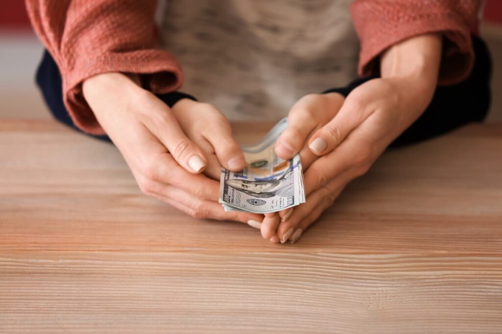 Woman with her son holding dollar Woman with her son holding dollar